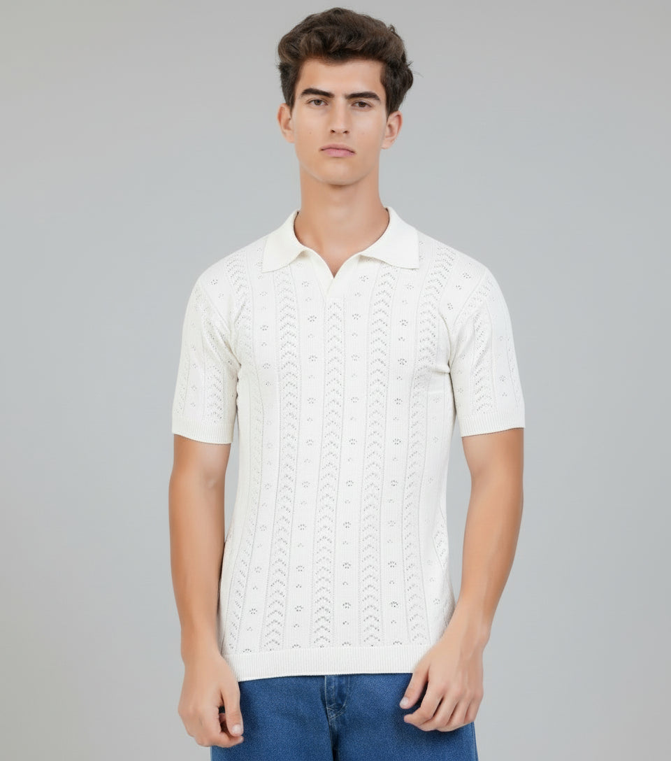 Man wearing a white knitted polo shirt against a gray background